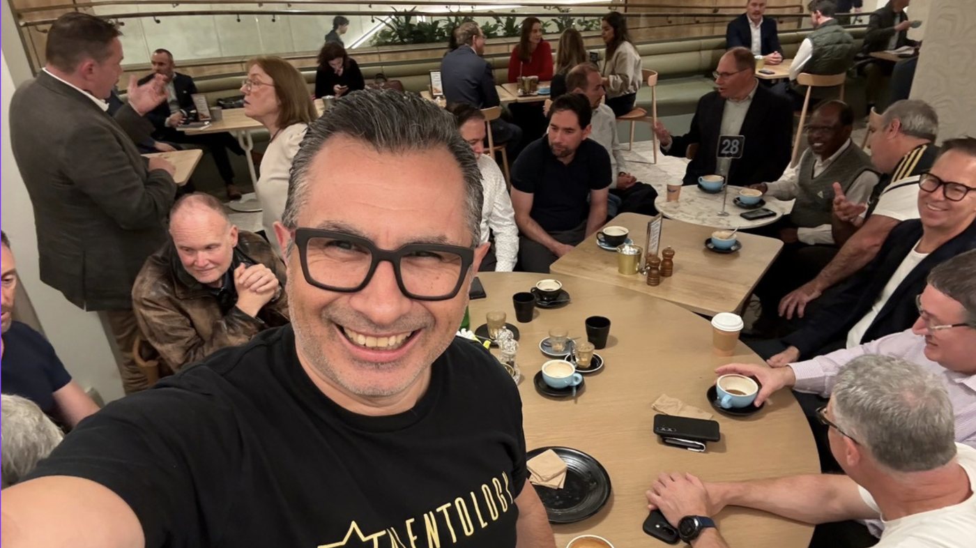 Trevor Churchley takes a selfie with a full table of job seekers at an in-person Job Seeker Caf&eacute; in Sydney